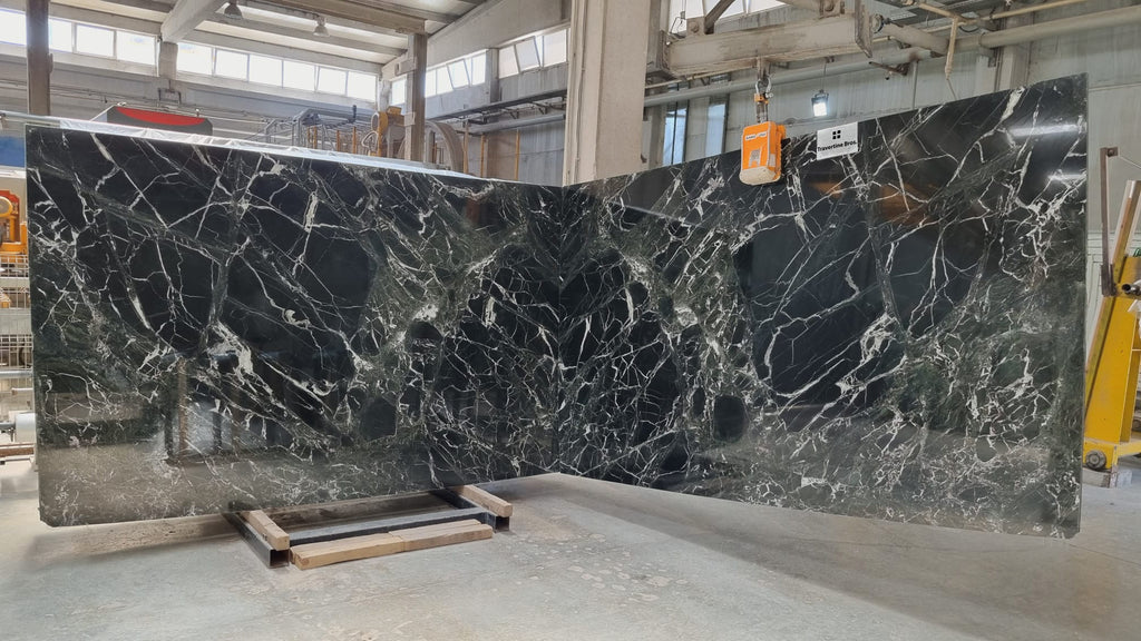 Dark green marble with white veining slabs book matched