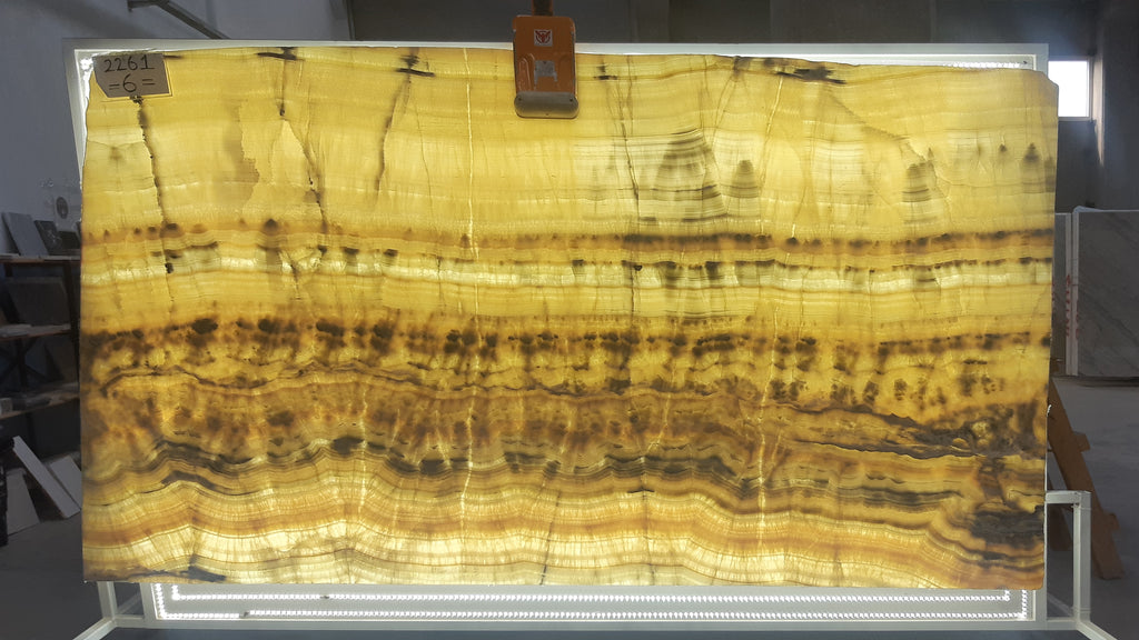 Beige Onyx with orange and blue veining slab back lit