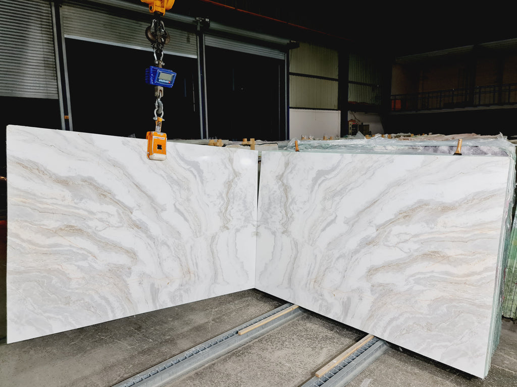 White marble with gray cloudy veining book matched slab.