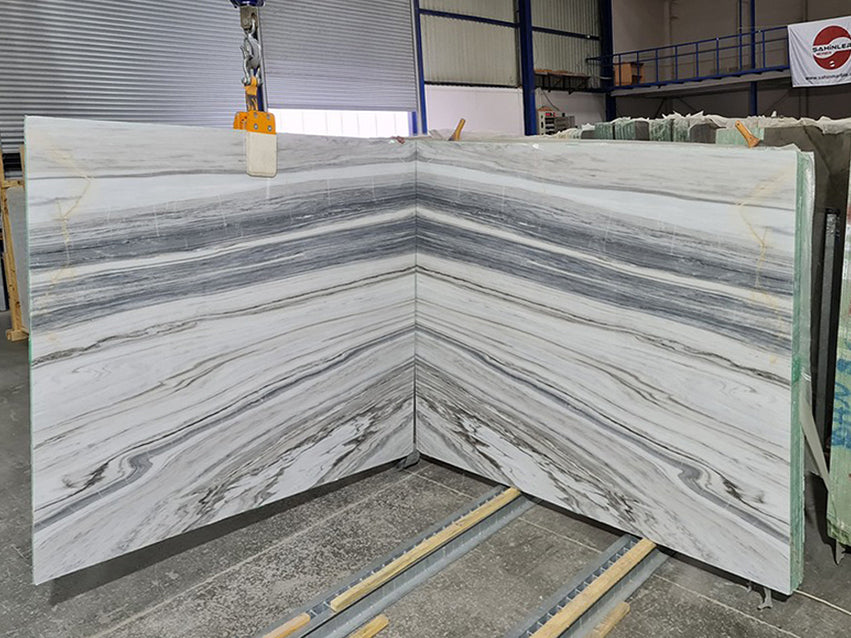 White marble with beige and gray veining slabs book matched