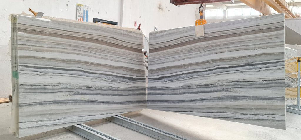 White marble with beige and gray veining slabs book matched