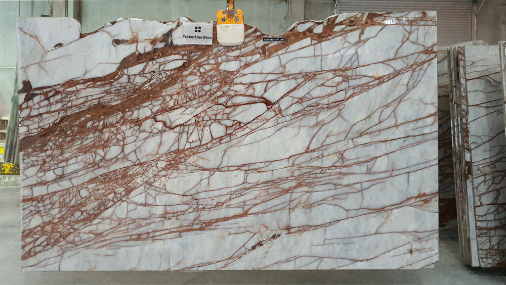 Slab of white marble with burnt red veining.