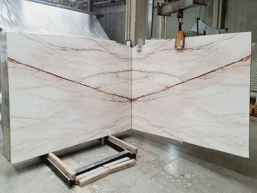 White marble with red veining slabs book matched