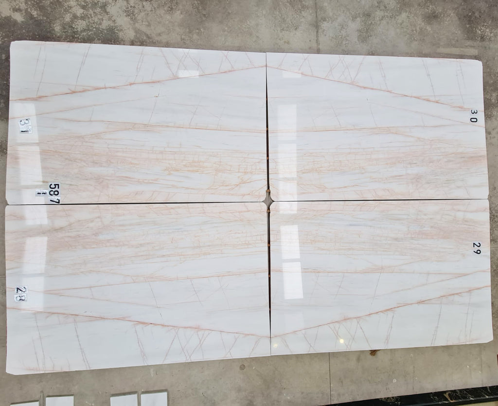 White marble with blush veining slabs book matched