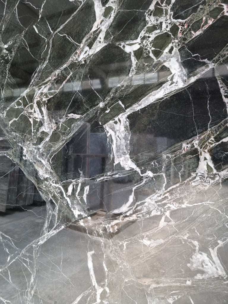 Dark green marble with white veining close up